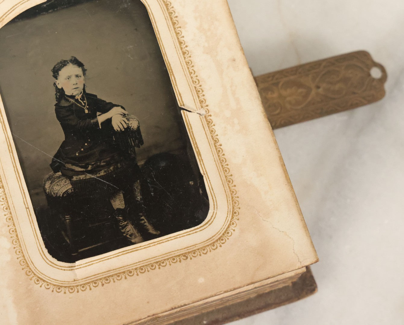 Lot 123 - Antique Cabinet Card And Tintype Family Photo Album, 3 C.D.V. Photos, 10 Tintypes, 2 Illustrated Album Filler Cards, Including Tintype Of Scowling Old Man And Illustrated Card Of Civil War Commander Foot, Cover With Harlequin And Fairy Motif