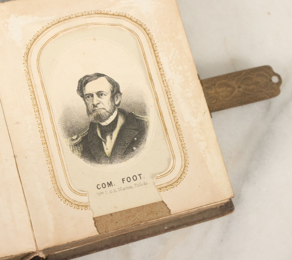 Lot 123 - Antique Cabinet Card And Tintype Family Photo Album, 3 C.D.V. Photos, 10 Tintypes, 2 Illustrated Album Filler Cards, Including Tintype Of Scowling Old Man And Illustrated Card Of Civil War Commander Foot, Cover With Harlequin And Fairy Motif