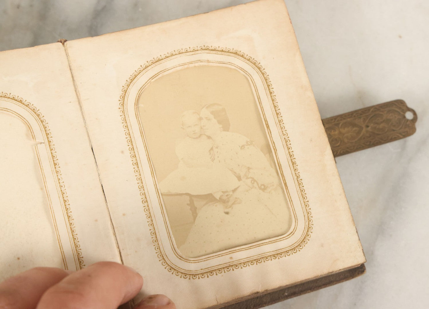 Lot 123 - Antique Cabinet Card And Tintype Family Photo Album, 3 C.D.V. Photos, 10 Tintypes, 2 Illustrated Album Filler Cards, Including Tintype Of Scowling Old Man And Illustrated Card Of Civil War Commander Foot, Cover With Harlequin And Fairy Motif