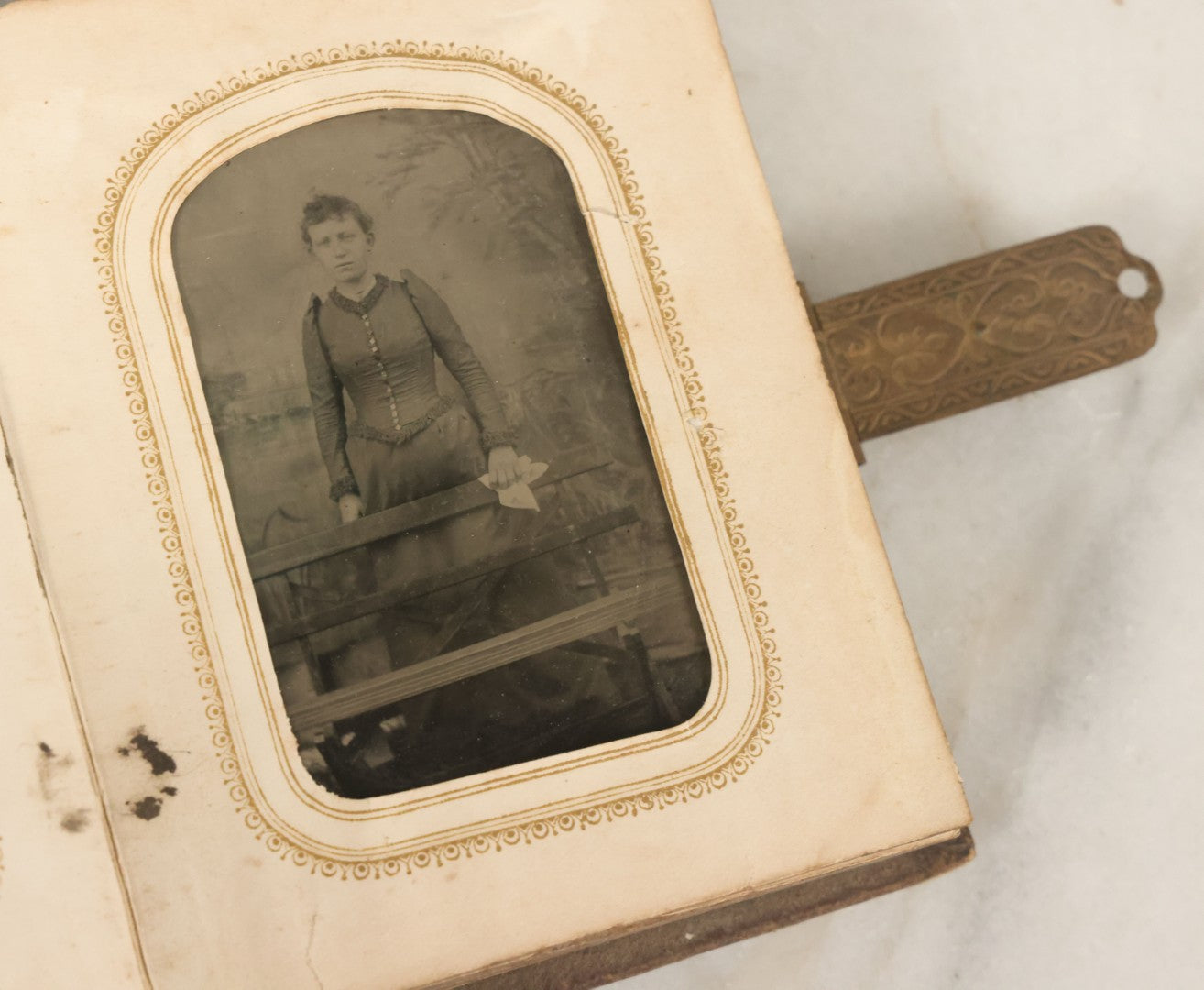 Lot 123 - Antique Cabinet Card And Tintype Family Photo Album, 3 C.D.V. Photos, 10 Tintypes, 2 Illustrated Album Filler Cards, Including Tintype Of Scowling Old Man And Illustrated Card Of Civil War Commander Foot, Cover With Harlequin And Fairy Motif