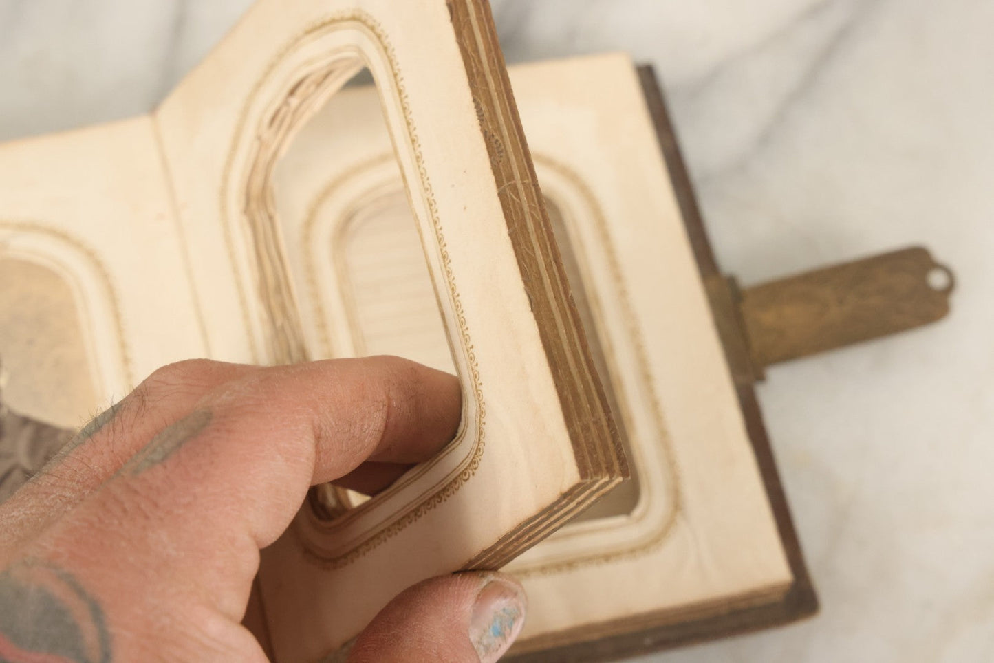 Lot 123 - Antique Cabinet Card And Tintype Family Photo Album, 3 C.D.V. Photos, 10 Tintypes, 2 Illustrated Album Filler Cards, Including Tintype Of Scowling Old Man And Illustrated Card Of Civil War Commander Foot, Cover With Harlequin And Fairy Motif