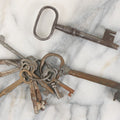 Lot 125 - Grouping Of 10+ Antique Skeleton Keys Including Two Large Gate Keys, Barrel Keys, And Others, Note One Large Key Has Crack