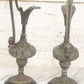 Lot 011 - Pair Of Antique Ornate Cast Pot Metal Ewers, With Woman's Head On Handle, And Woman's Head In Profile, Greek Key Design, Note Crack In Handle And Crack On Base Of One, 10-5/8" High Each