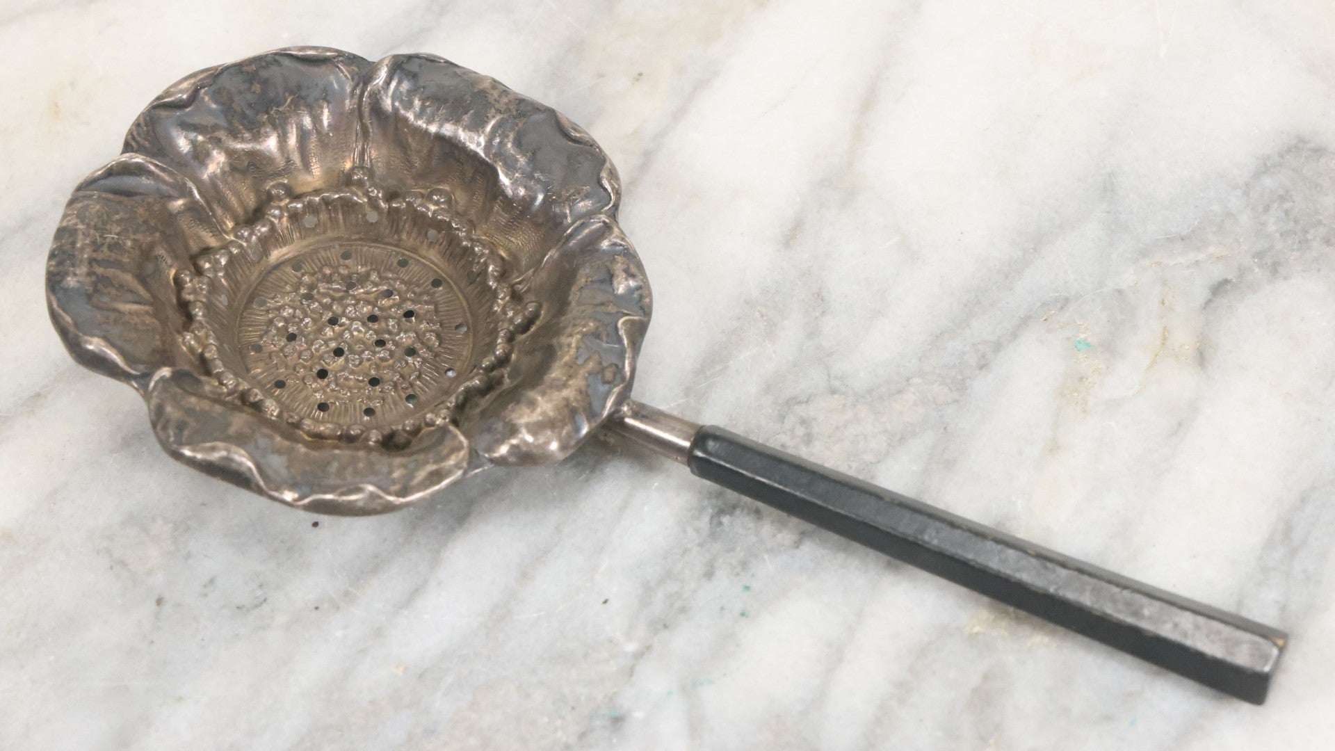 Lot 028 - Antique Sterling Silver Anemone Flower Tea Strainer With Octagonal Black Lacquered Wooden Handle, Marked "Sterling-A"