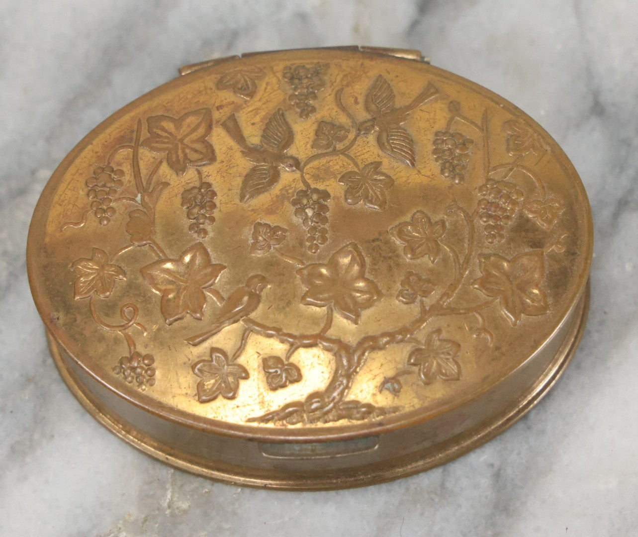 Lot 037 - Antique Oval Shaped Brass Pill Box With Hinged Lid With Bird And Grapes Motif, Marked Volupte, U.S.A.