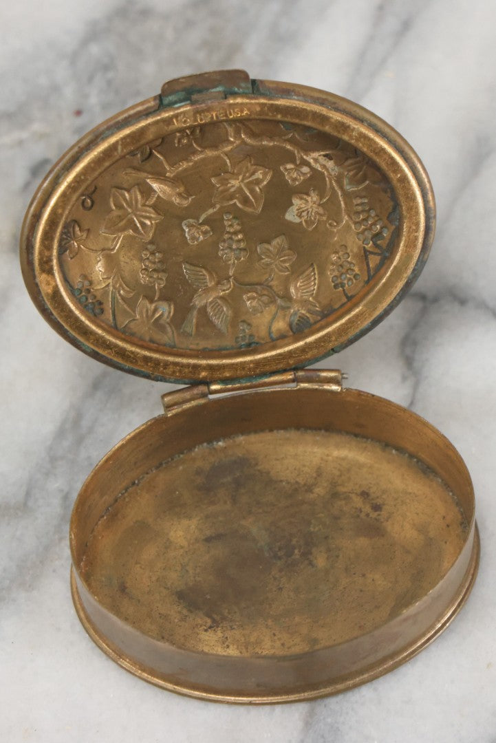 Lot 037 - Antique Oval Shaped Brass Pill Box With Hinged Lid With Bird And Grapes Motif, Marked Volupte, U.S.A.
