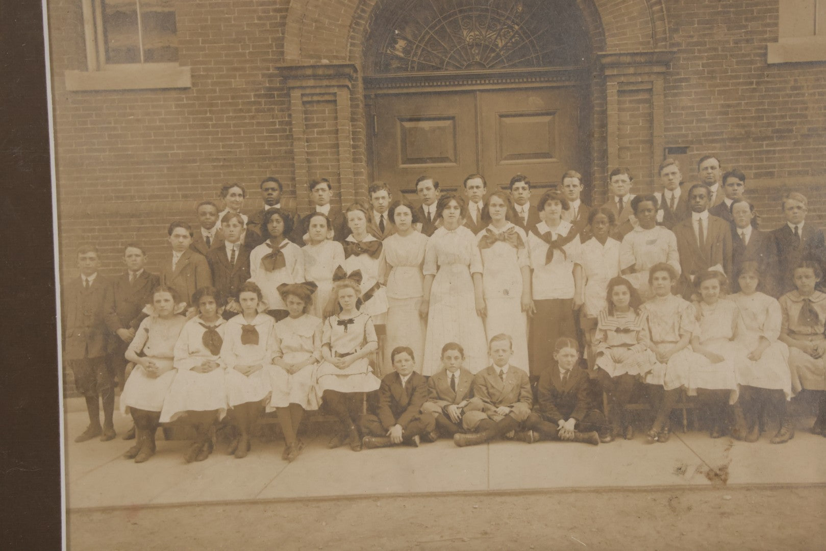 Lot 068 - Antique Photograph Of Schoolchildren, Interracial Class, Outside Of Brick Schoolhouse Including Many Young Girls And Boys And Teachers, Matted And Shrink Wrapped