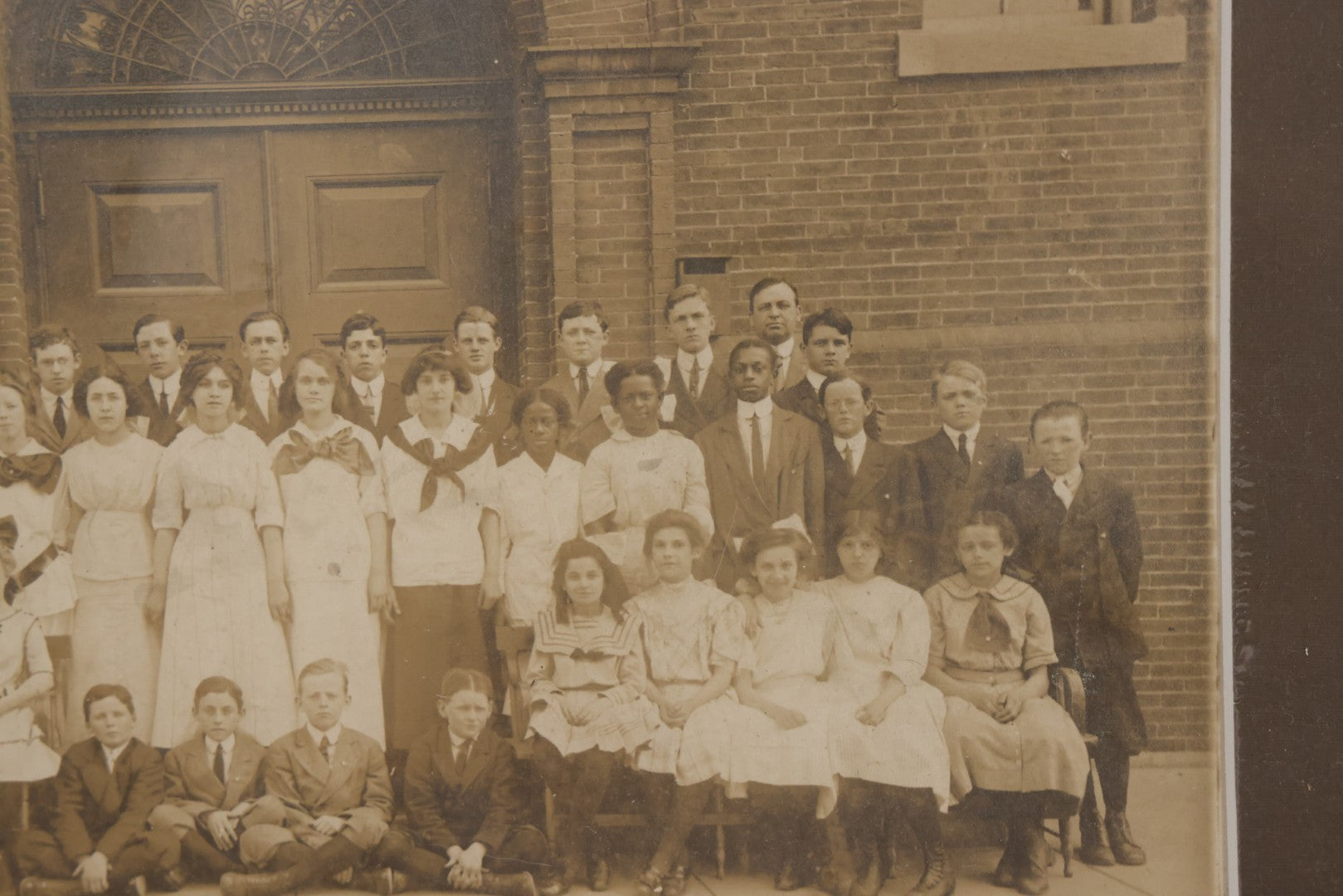 Lot 068 - Antique Photograph Of Schoolchildren, Interracial Class, Outside Of Brick Schoolhouse Including Many Young Girls And Boys And Teachers, Matted And Shrink Wrapped