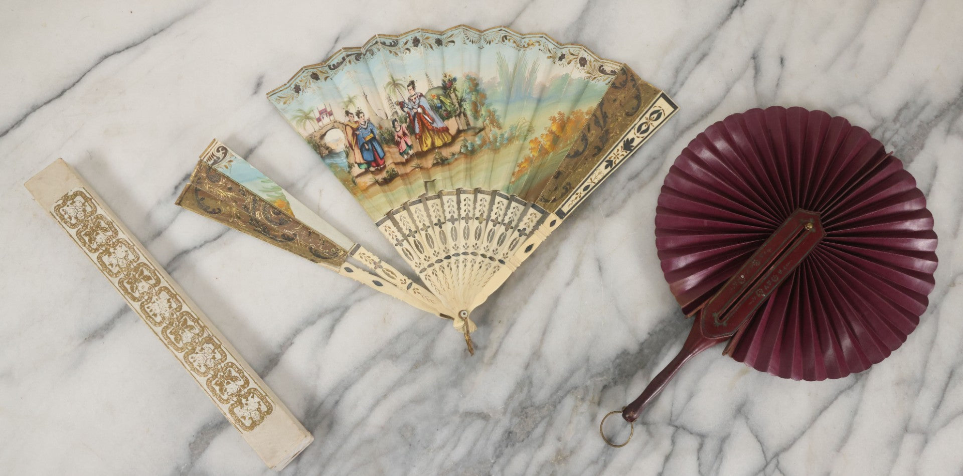 Lot 089 - Pair Of Antique Hand Fans Including Hand Painted In Original Box (Note, Vertical Tear In Fan), And Purple Maroon Pop Up Fan With Slide Mechanism
