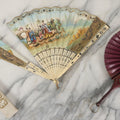 Lot 089 - Pair Of Antique Hand Fans Including Hand Painted In Original Box (Note, Vertical Tear In Fan), And Purple Maroon Pop Up Fan With Slide Mechanism