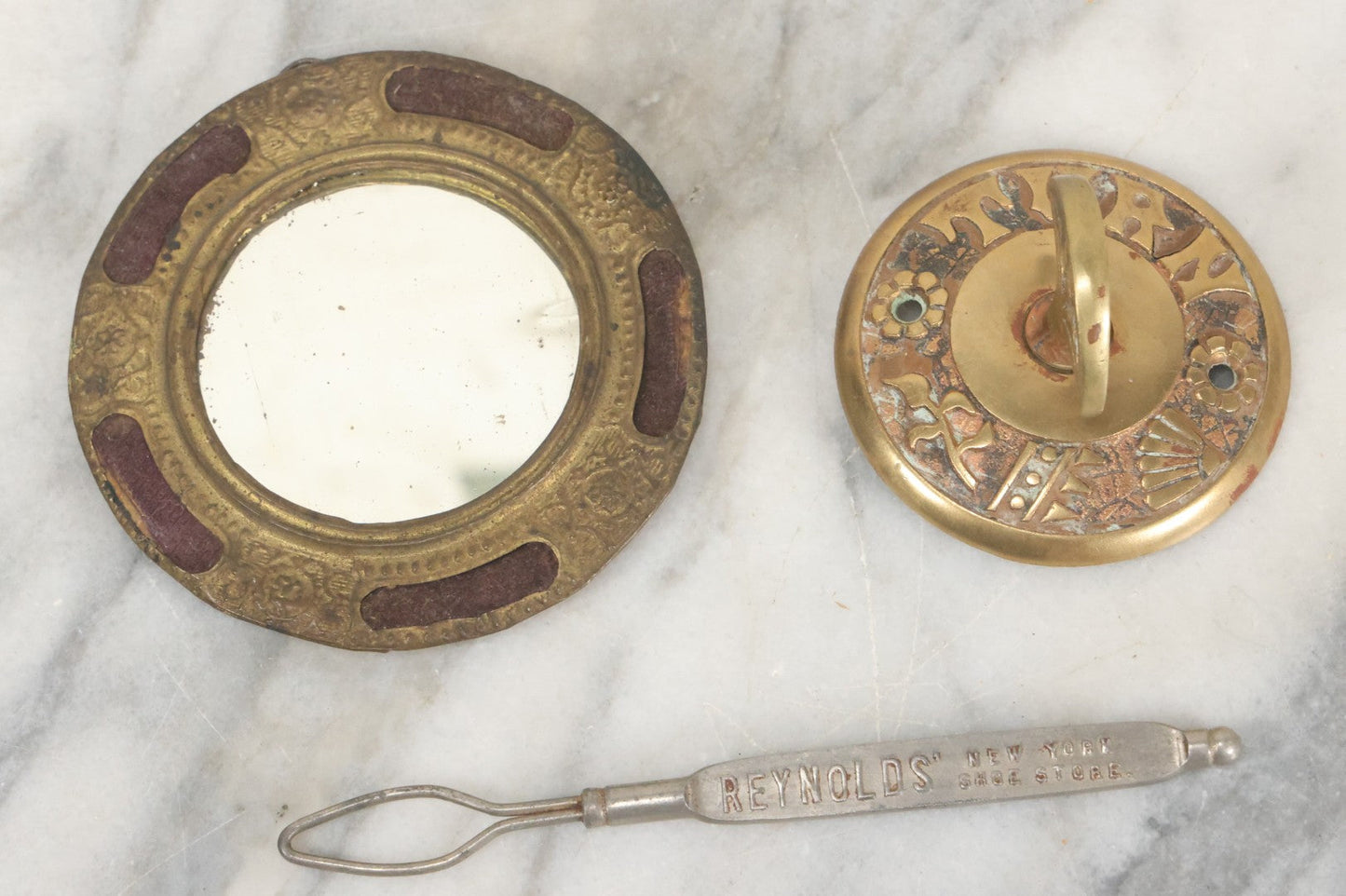 Lot 092 - Antique 3 Item Metal Grouping Including Miniature Pocket Mirror, Brass Doorbell Knob, And Advertising Button Hook For Reynolds' Shoe Store, Milford Massachusetts