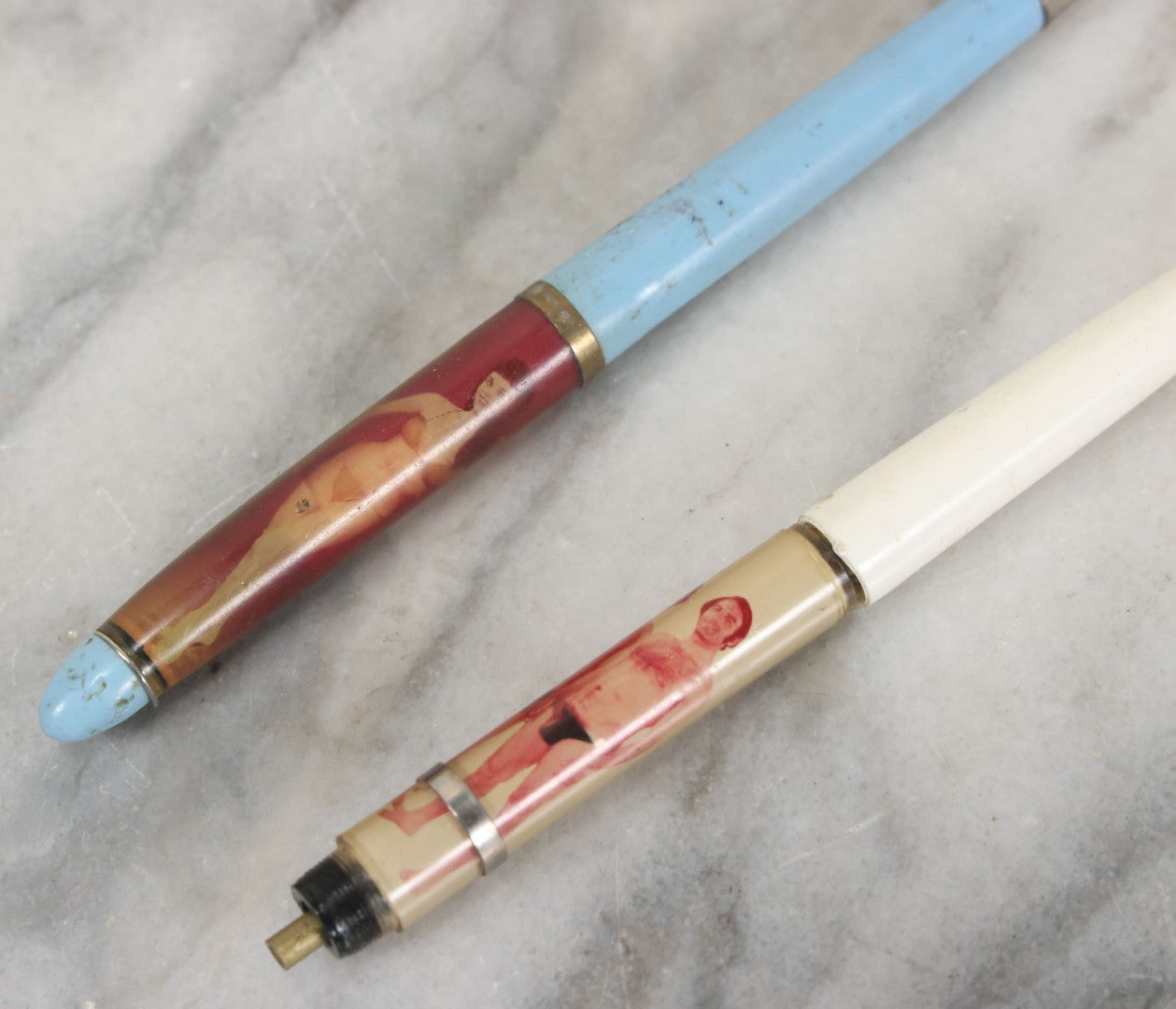 Lot 098 - Pair Of Vintage Pinup Nudie Pens Including Woman With Disappearing Dress And Two Men In Spandex, Note Pen With Men Missing Parts And Nude Effect Not Working, Pens Do Not Write