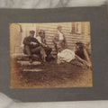 Lot 053 - Antique Boarded Photograph Of Fishermen, Hunters Smoking Pipes On The Stoop Of A House, With Hunting Dog Beagle In Photo