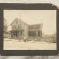 Lot 055 - Antique Boarded Photograph Of A Couple With Dwarfism Posing Outside Of A House / General Store With A Sign Reading "Confectionary, Tonics, Cigars, And Tobacco"