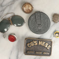 Lot 106 - Seven Piece Mixed Metal Objects Grouping Including Motorcycle License Plate Reflector, Sunglasses, Photo Button, Pocket Mirror, Pinback Button, Belt Buckle, And School Safety Patrol Button