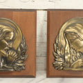 Lot 068 - Pair Of Cast Metal Religious Decor Plaques With Jesus Christ And The Virgin Mary, Mounted To Wood Panel