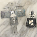 Lot 079 - Pair Of Vintage Cast Metal Pharmacists Medical Doctor License Plate Badges Including Chrome Badge And Black And White Painted Emblem