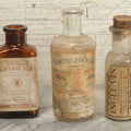 Lot 006 - Grouping Of Five Antique And Vintage Pharmacy Bottles With Paper Labels, Including "Solon" Herb Pills, Ingluvin Bottle, Powder Of Pepsin Bottle, And Campho-Phenique Bottle