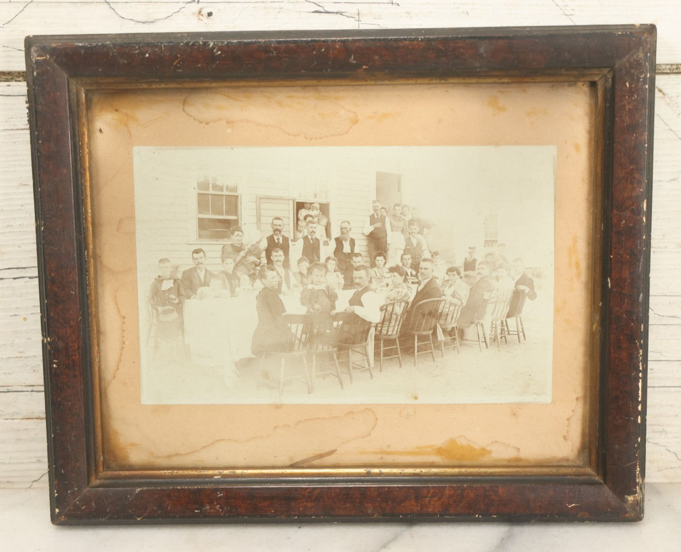 Lot 094 - Antique Framed Boarded Photograph Of A Large Family Gathering Meal Outside, Possibly Thanksgiving Or Like Occasion, With Many Men, Women, And Children In Photo, Overall Dimensions 11-1/2" x 9-3/8"
