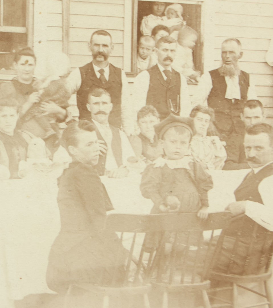 Lot 094 - Antique Framed Boarded Photograph Of A Large Family Gathering Meal Outside, Possibly Thanksgiving Or Like Occasion, With Many Men, Women, And Children In Photo, Overall Dimensions 11-1/2" x 9-3/8"