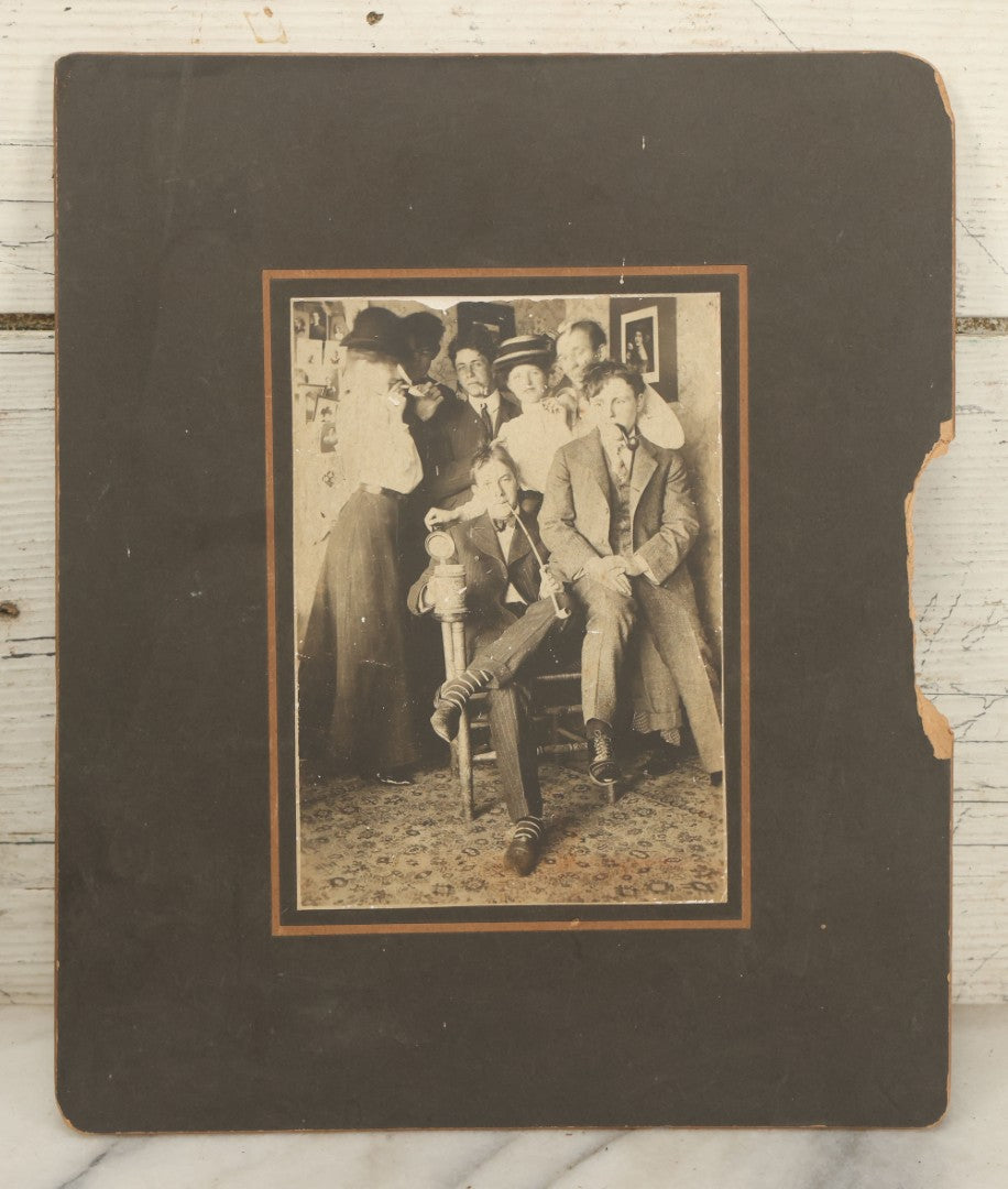 Lot 098 - Antique Boarded Photograph Of Friends Goofing Off, Smoking Pipes, Two Women And Five Men, Titled "The Degenerates" On Verso, Note Loss To Right Side Of Board