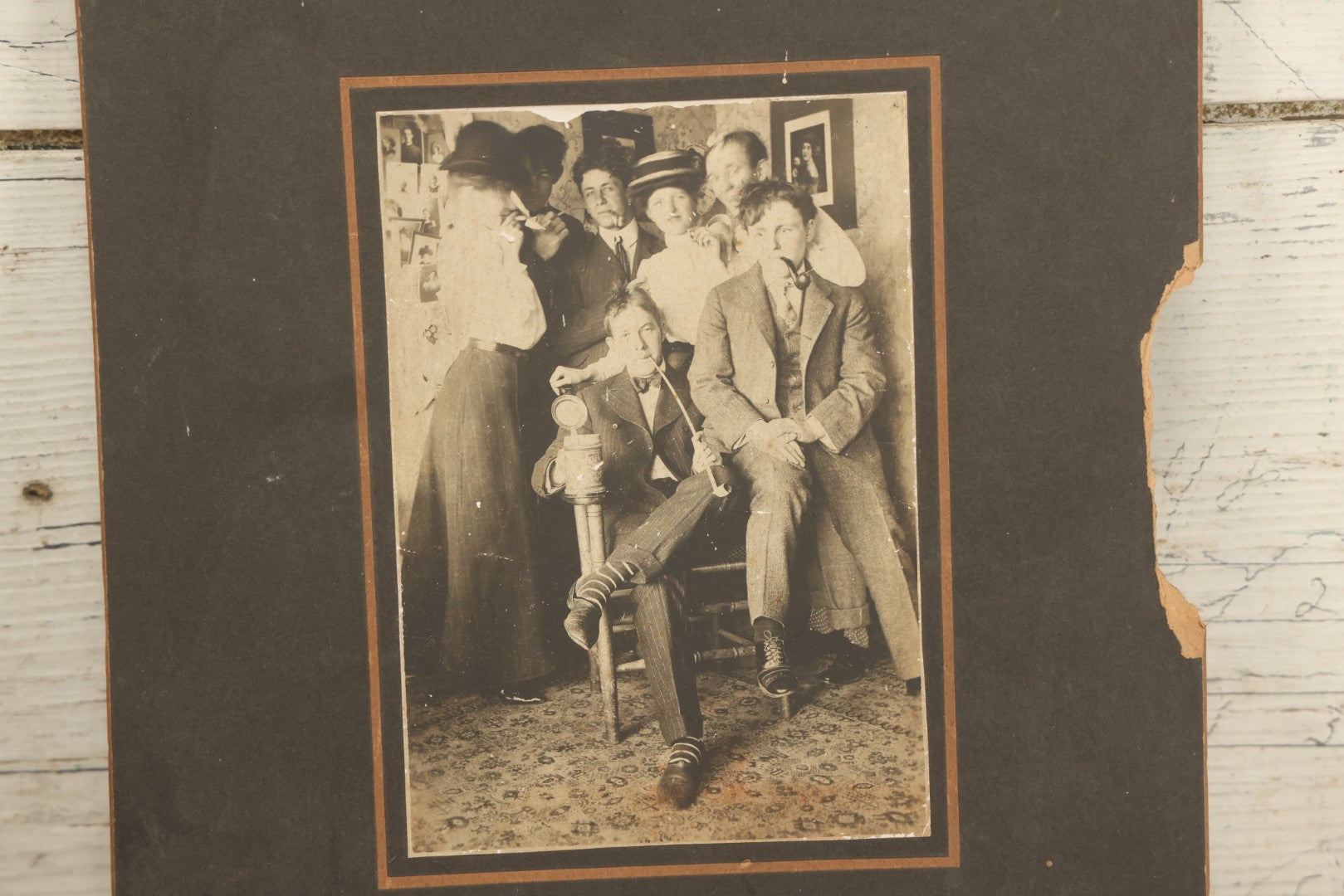 Lot 098 - Antique Boarded Photograph Of Friends Goofing Off, Smoking Pipes, Two Women And Five Men, Titled "The Degenerates" On Verso, Note Loss To Right Side Of Board