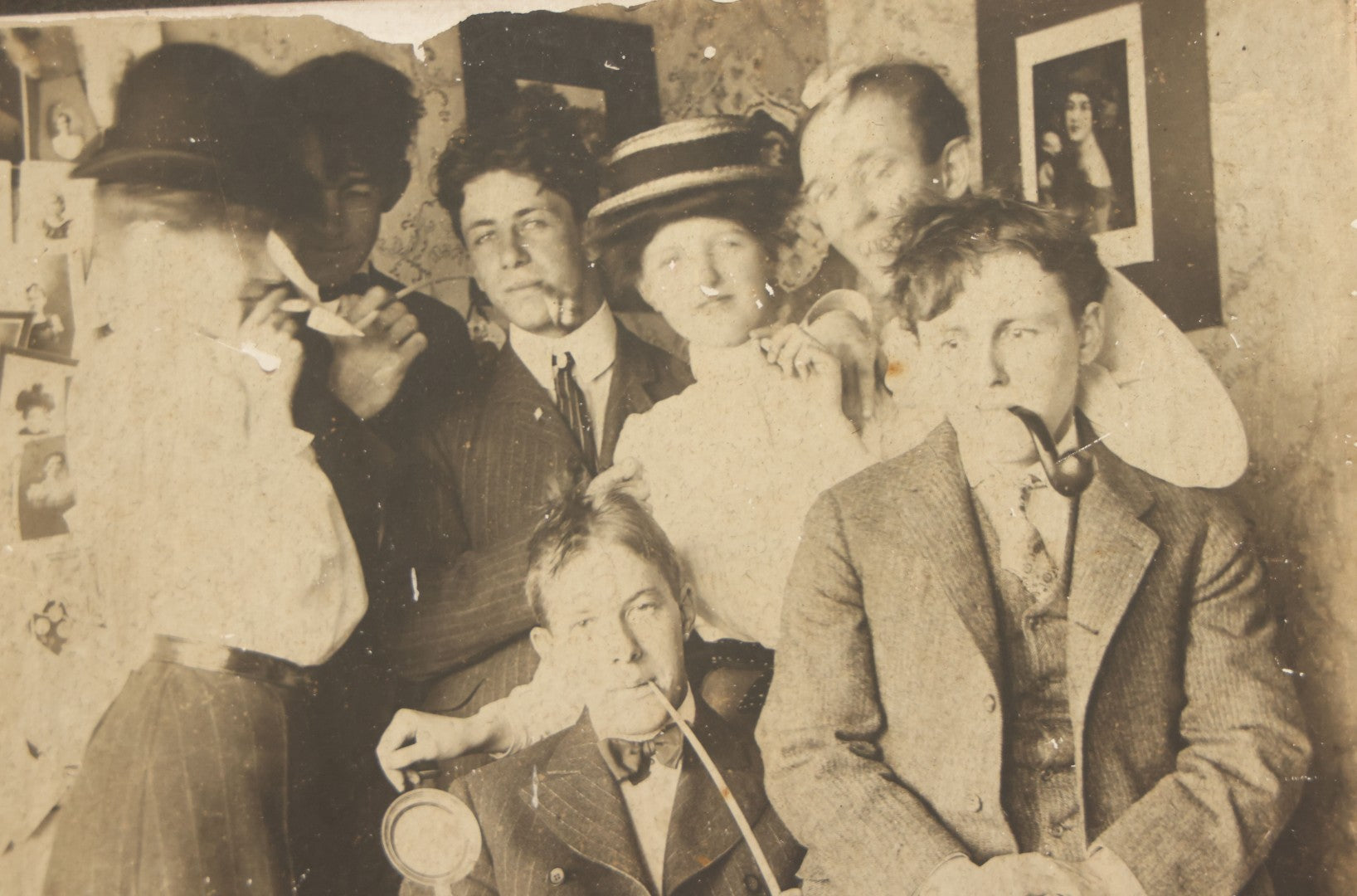 Lot 098 - Antique Boarded Photograph Of Friends Goofing Off, Smoking Pipes, Two Women And Five Men, Titled "The Degenerates" On Verso, Note Loss To Right Side Of Board