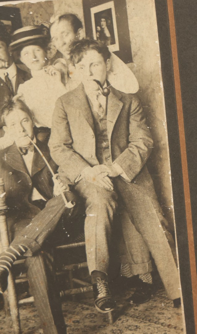 Lot 098 - Antique Boarded Photograph Of Friends Goofing Off, Smoking Pipes, Two Women And Five Men, Titled "The Degenerates" On Verso, Note Loss To Right Side Of Board