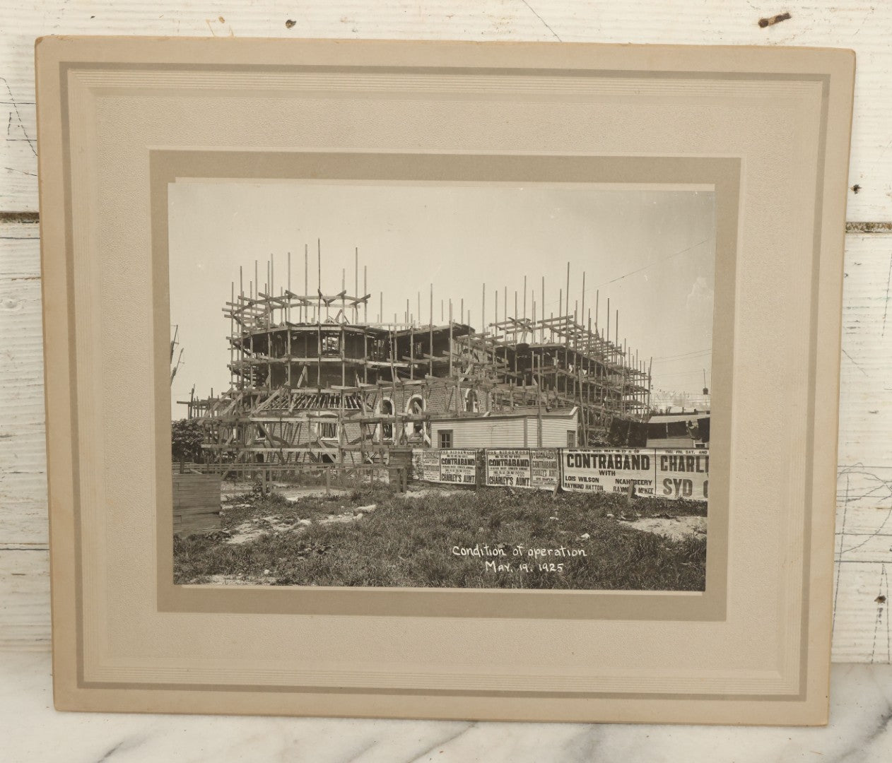 Lot 100 - Single Antique Boarded Photo Depicting A Building Under Construction, Possibly A Church In Queens, New York, With Posters Advertising The Fox Ridgewood Theater, Photo Marked "Condition Of Operations, May 19, 1925"