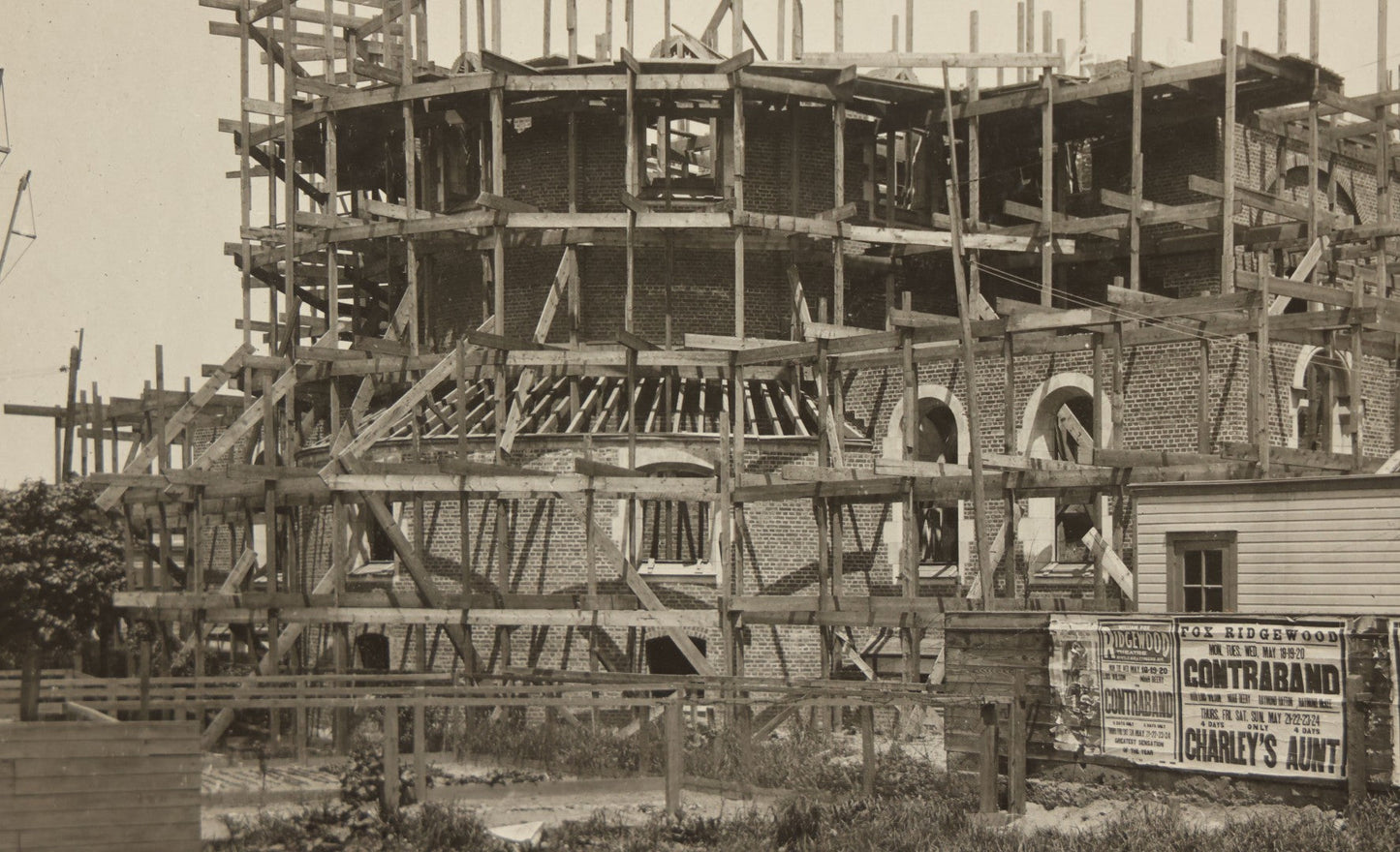 Lot 100 - Single Antique Boarded Photo Depicting A Building Under Construction, Possibly A Church In Queens, New York, With Posters Advertising The Fox Ridgewood Theater, Photo Marked "Condition Of Operations, May 19, 1925"