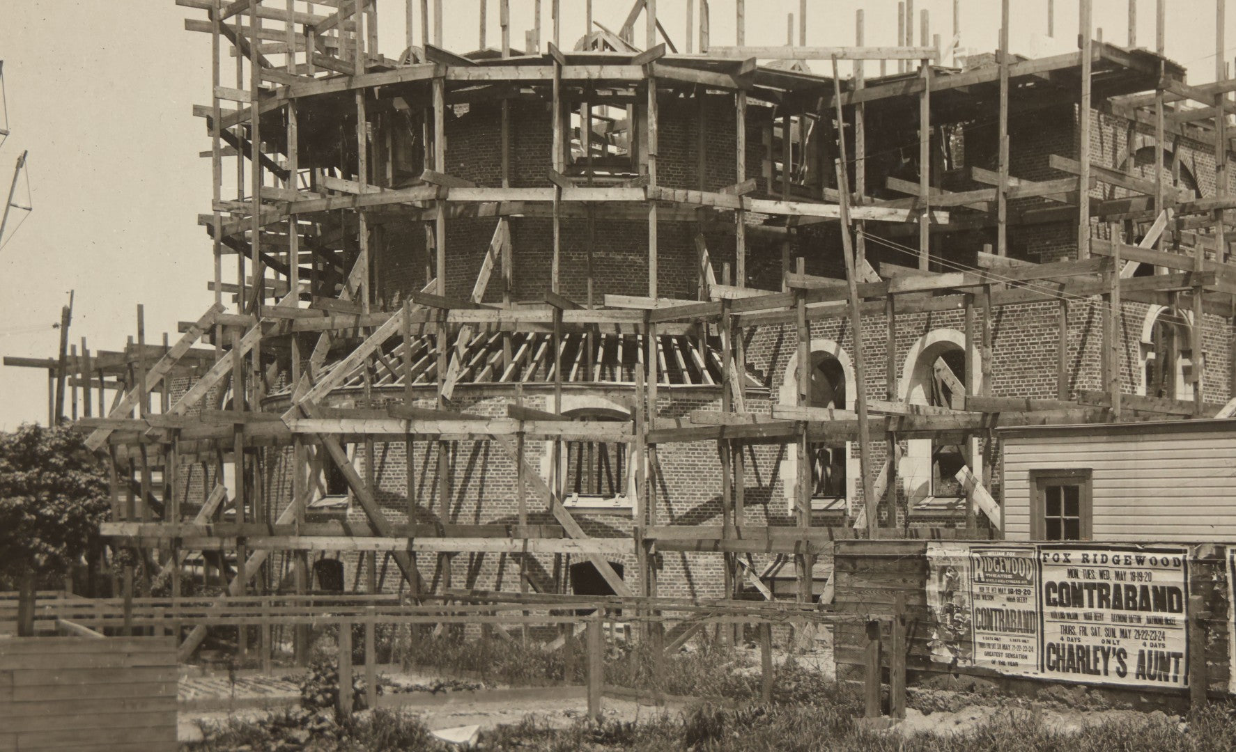 Lot 100 - Single Antique Boarded Photo Depicting A Building Under Construction, Possibly A Church In Queens, New York, With Posters Advertising The Fox Ridgewood Theater, Photo Marked "Condition Of Operations, May 19, 1925"