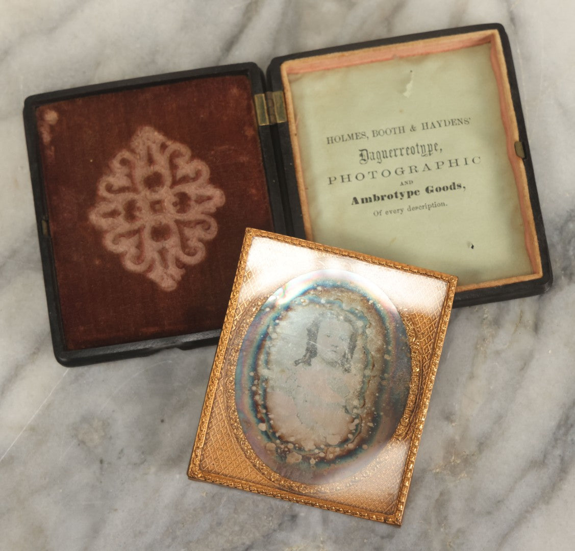 Lot 013 - Antique 1/6th Plate Daguerreotype Photograph Of A Young Girl In A White Dress Holding Her Hand To Her Chest, In Thermoplastic Case Manufactured By Hoolmes, Booth, & Haydens' Daguerreotype, Photographic, And Ambrotype Goods