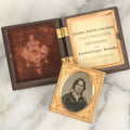 Lot 014 - Antique 1/16th Plate Ruby Ambrotype Photograph Of A Pretty Young Woman With A Long Ribbon In Her Hair In A Pictorial Thermoplastic Case Manufactured By Hoolmes, Booth, & Haydens' Daguerreotype, Photographic, And Ambrotype Goods