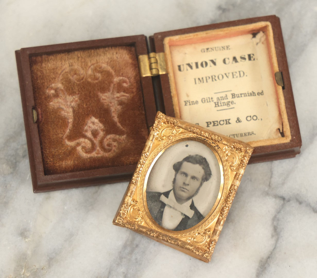 Lot 015 - Antique 1/16th Plate Ambrotype Photograph Of A Man With A 1000 Yard Stare A Comically Wide White Bowtie In A Thermoplastic Case, Genuine Union Case, Improved, Manufactured By S. Peck & Co.