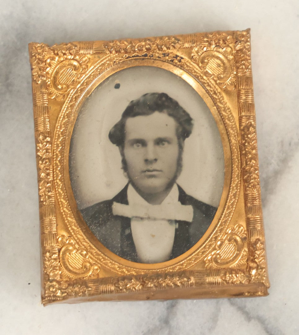 Lot 015 - Antique 1/16th Plate Ambrotype Photograph Of A Man With A 1000 Yard Stare A Comically Wide White Bowtie In A Thermoplastic Case, Genuine Union Case, Improved, Manufactured By S. Peck & Co.