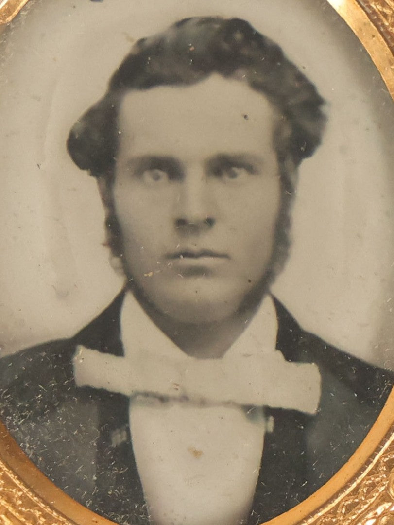 Lot 015 - Antique 1/16th Plate Ambrotype Photograph Of A Man With A 1000 Yard Stare A Comically Wide White Bowtie In A Thermoplastic Case, Genuine Union Case, Improved, Manufactured By S. Peck & Co.