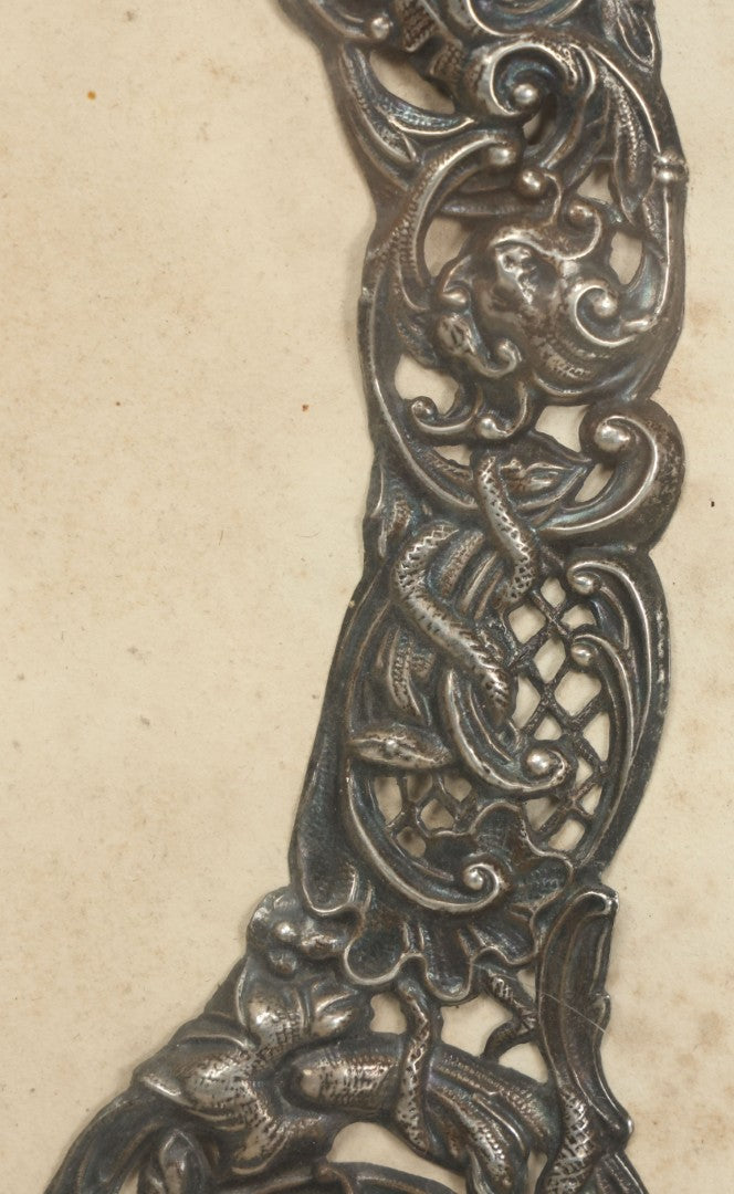 Lot 022 - Antique Sterling Silver Repoussé Gothic Revival Art Nouveau Frame Front With Numerous Green Man Motifs, Framed Behind Glass, Approximately 2.8 Troy Ounces