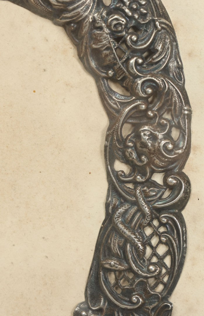 Lot 022 - Antique Sterling Silver Repoussé Gothic Revival Art Nouveau Frame Front With Numerous Green Man Motifs, Framed Behind Glass, Approximately 2.8 Troy Ounces