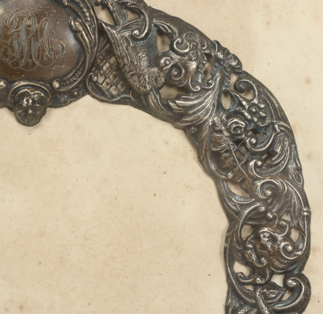 Lot 022 - Antique Sterling Silver Repoussé Gothic Revival Art Nouveau Frame Front With Numerous Green Man Motifs, Framed Behind Glass, Approximately 2.8 Troy Ounces