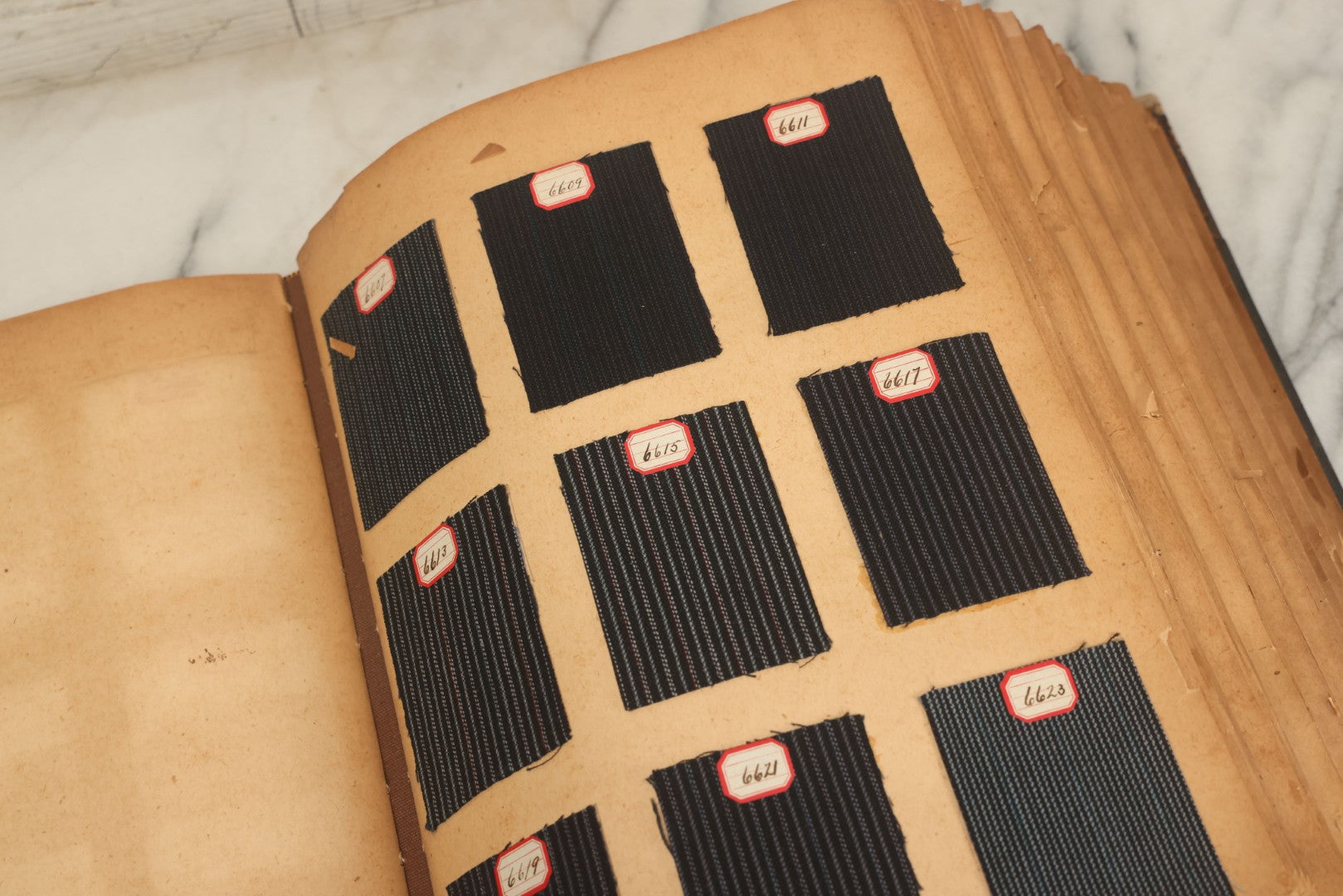 Lot 031 - Antique Sample Fabric Wool Swatch Book From Calumet Woolen Co., Styles No. And/Or Great River Woolen Co., Styles No. 6107-7785, Containing Dozens Of Fabric Samples, Missing Spine Covering, Circa 1894 