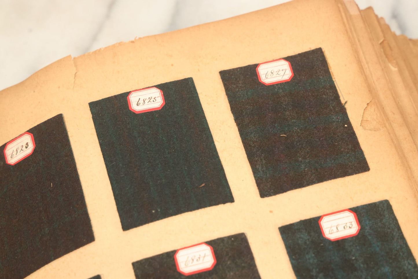 Lot 031 - Antique Sample Fabric Wool Swatch Book From Calumet Woolen Co., Styles No. And/Or Great River Woolen Co., Styles No. 6107-7785, Containing Dozens Of Fabric Samples, Missing Spine Covering, Circa 1894 