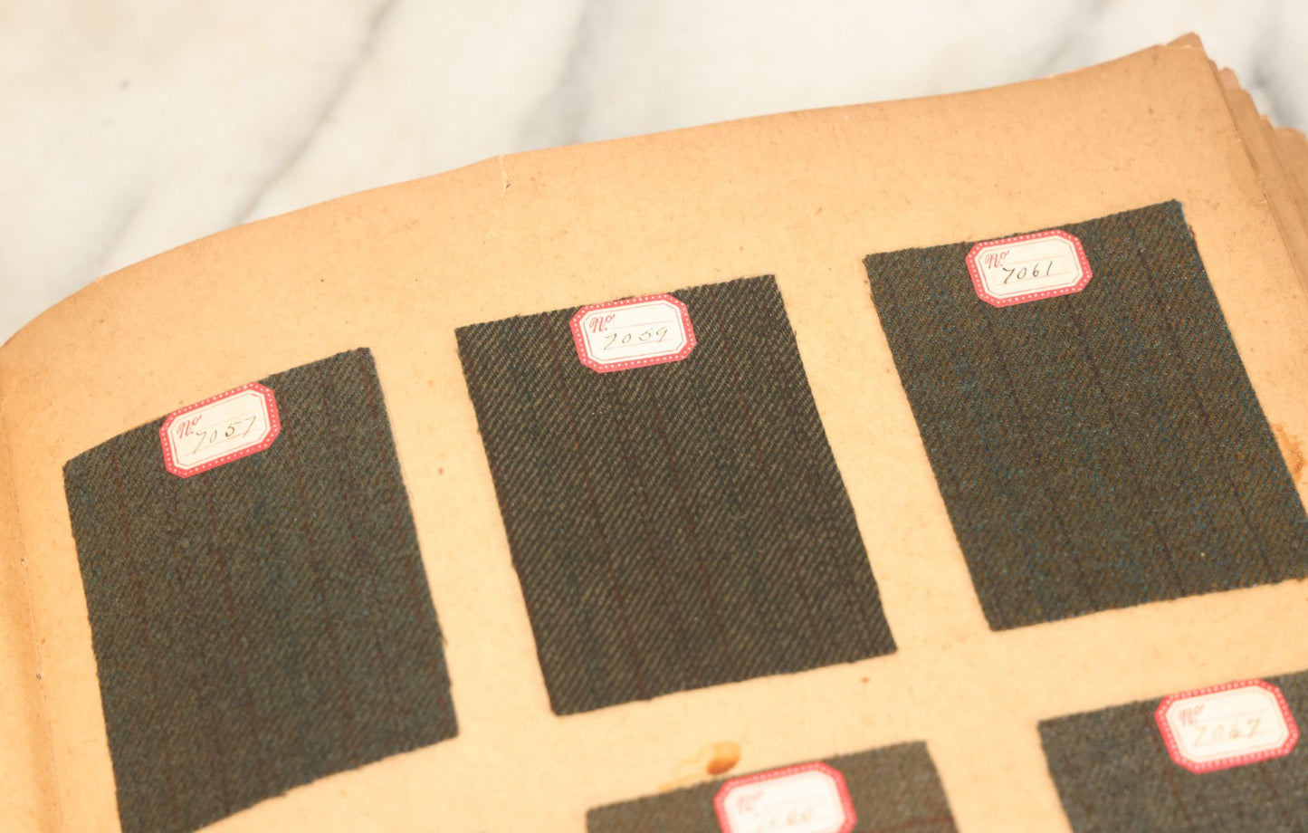 Lot 031 - Antique Sample Fabric Wool Swatch Book From Calumet Woolen Co., Styles No. And/Or Great River Woolen Co., Styles No. 6107-7785, Containing Dozens Of Fabric Samples, Missing Spine Covering, Circa 1894 