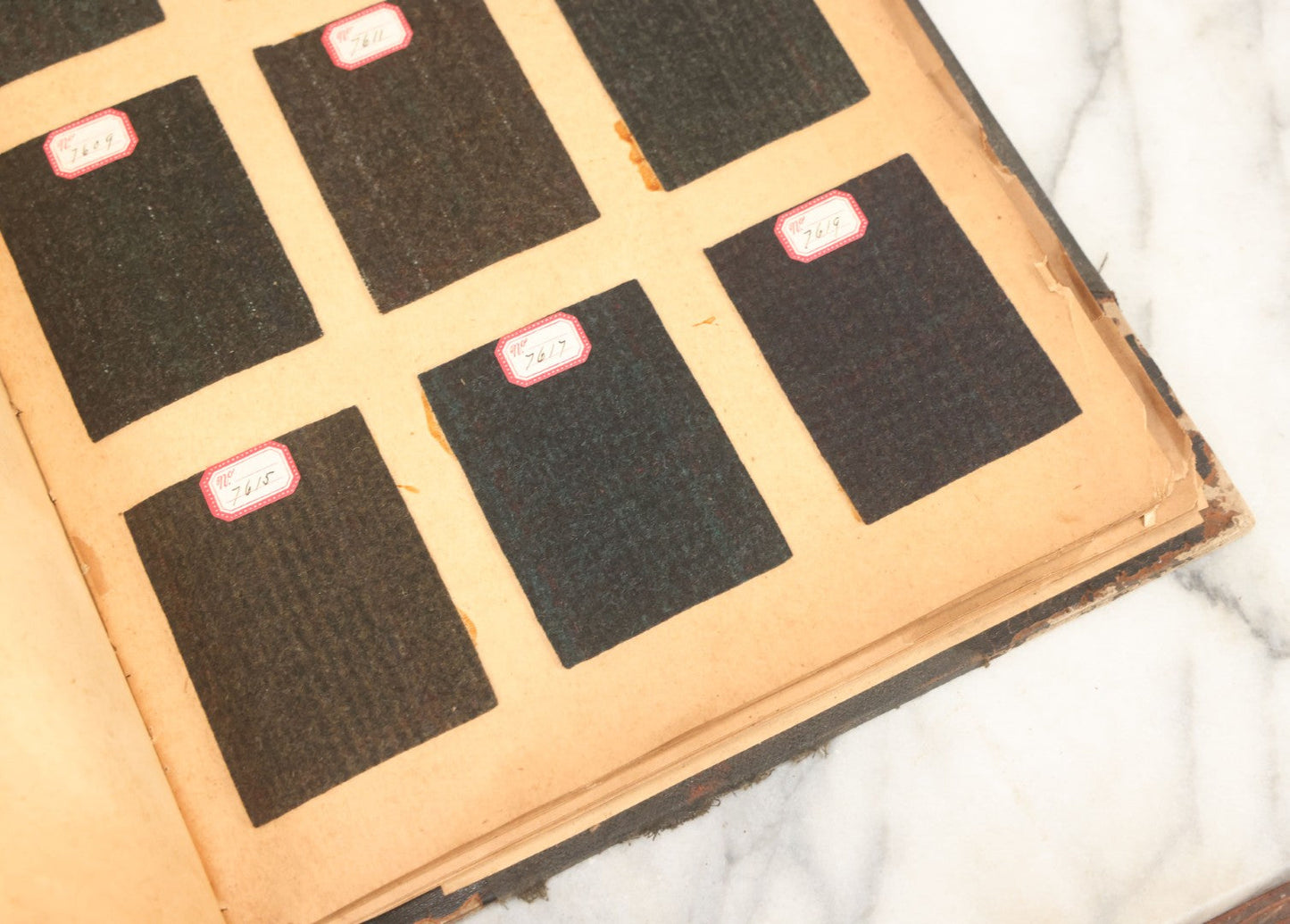 Lot 031 - Antique Sample Fabric Wool Swatch Book From Calumet Woolen Co., Styles No. And/Or Great River Woolen Co., Styles No. 6107-7785, Containing Dozens Of Fabric Samples, Missing Spine Covering, Circa 1894 