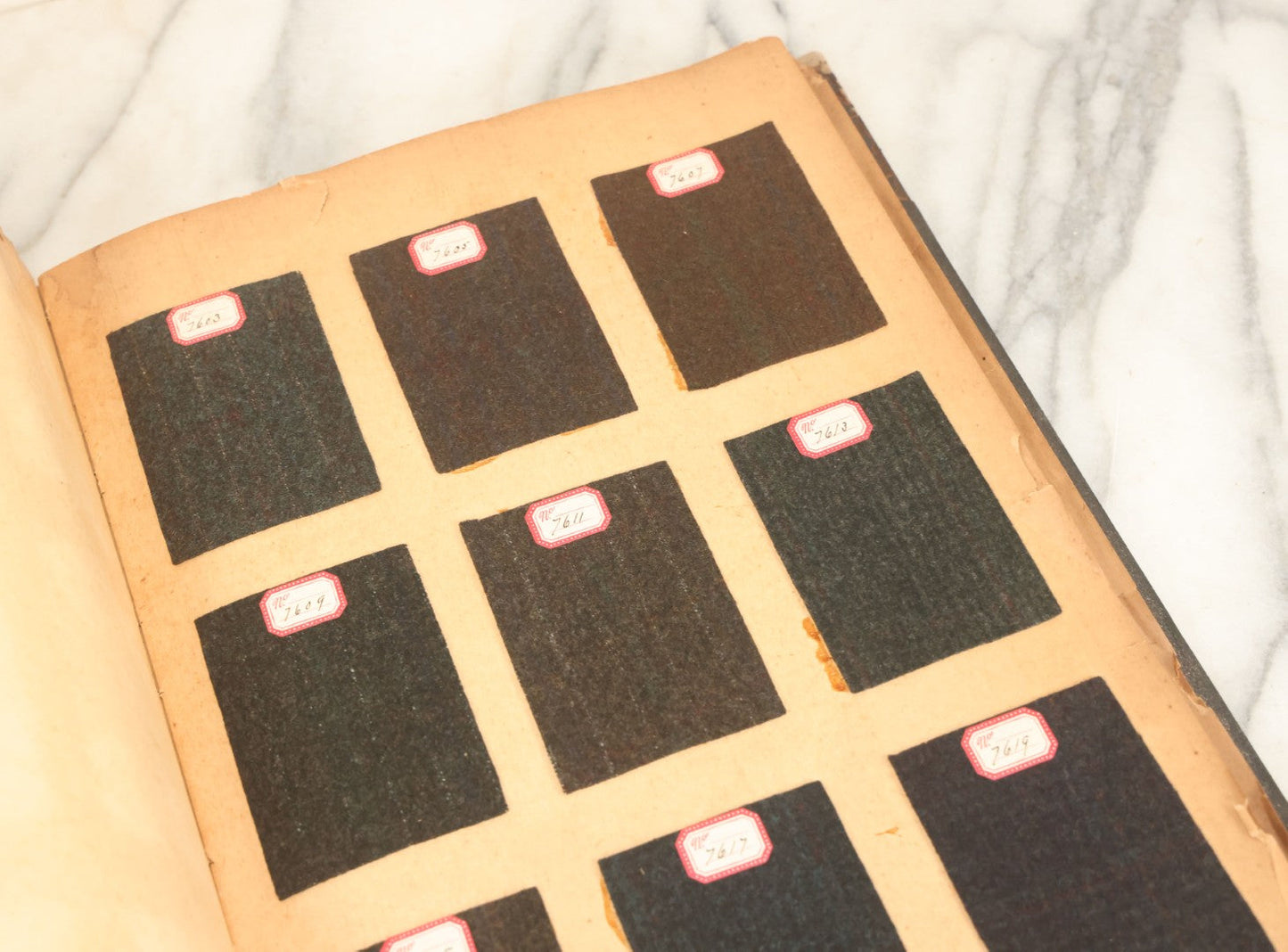 Lot 031 - Antique Sample Fabric Wool Swatch Book From Calumet Woolen Co., Styles No. And/Or Great River Woolen Co., Styles No. 6107-7785, Containing Dozens Of Fabric Samples, Missing Spine Covering, Circa 1894 