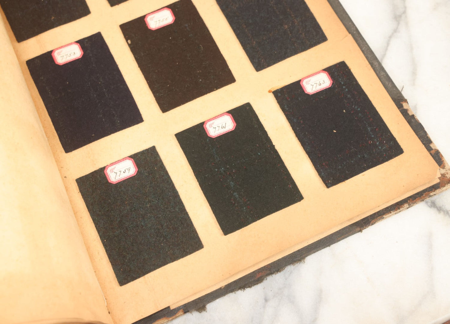 Lot 031 - Antique Sample Fabric Wool Swatch Book From Calumet Woolen Co., Styles No. And/Or Great River Woolen Co., Styles No. 6107-7785, Containing Dozens Of Fabric Samples, Missing Spine Covering, Circa 1894 