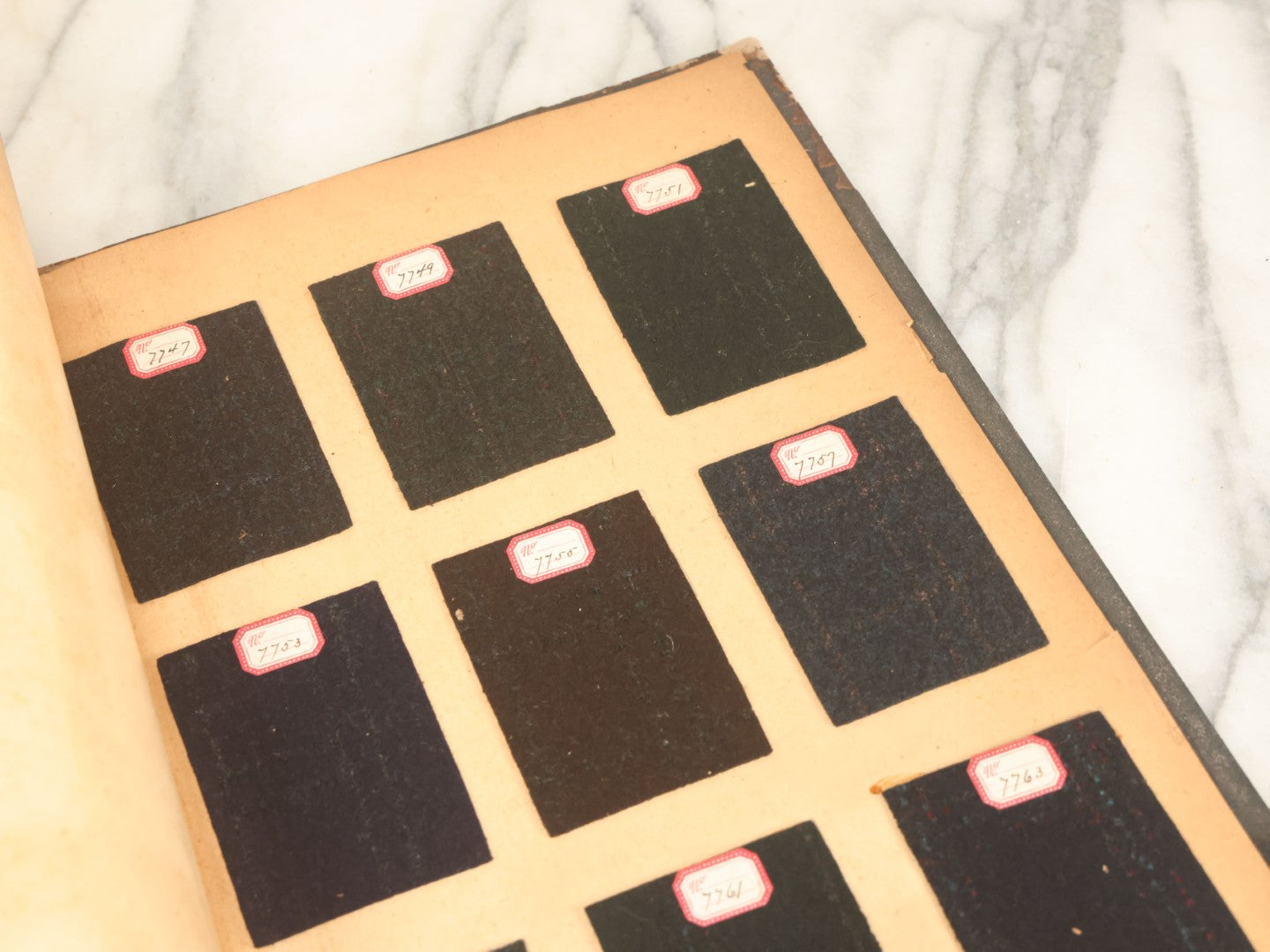 Lot 031 - Antique Sample Fabric Wool Swatch Book From Calumet Woolen Co., Styles No. And/Or Great River Woolen Co., Styles No. 6107-7785, Containing Dozens Of Fabric Samples, Missing Spine Covering, Circa 1894 