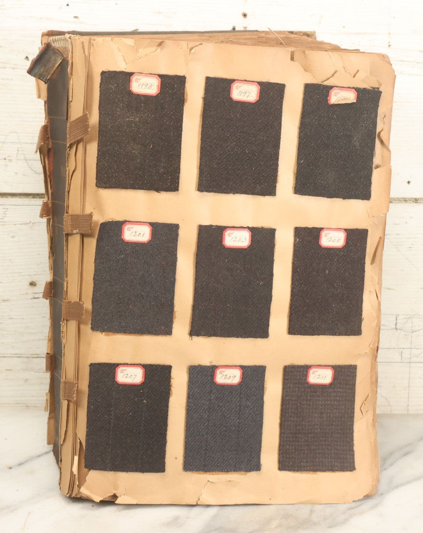 Lot 031 - Antique Sample Fabric Wool Swatch Book From Calumet Woolen Co., Styles No. And/Or Great River Woolen Co., Styles No. 6107-7785, Containing Dozens Of Fabric Samples, Missing Spine Covering, Circa 1894 