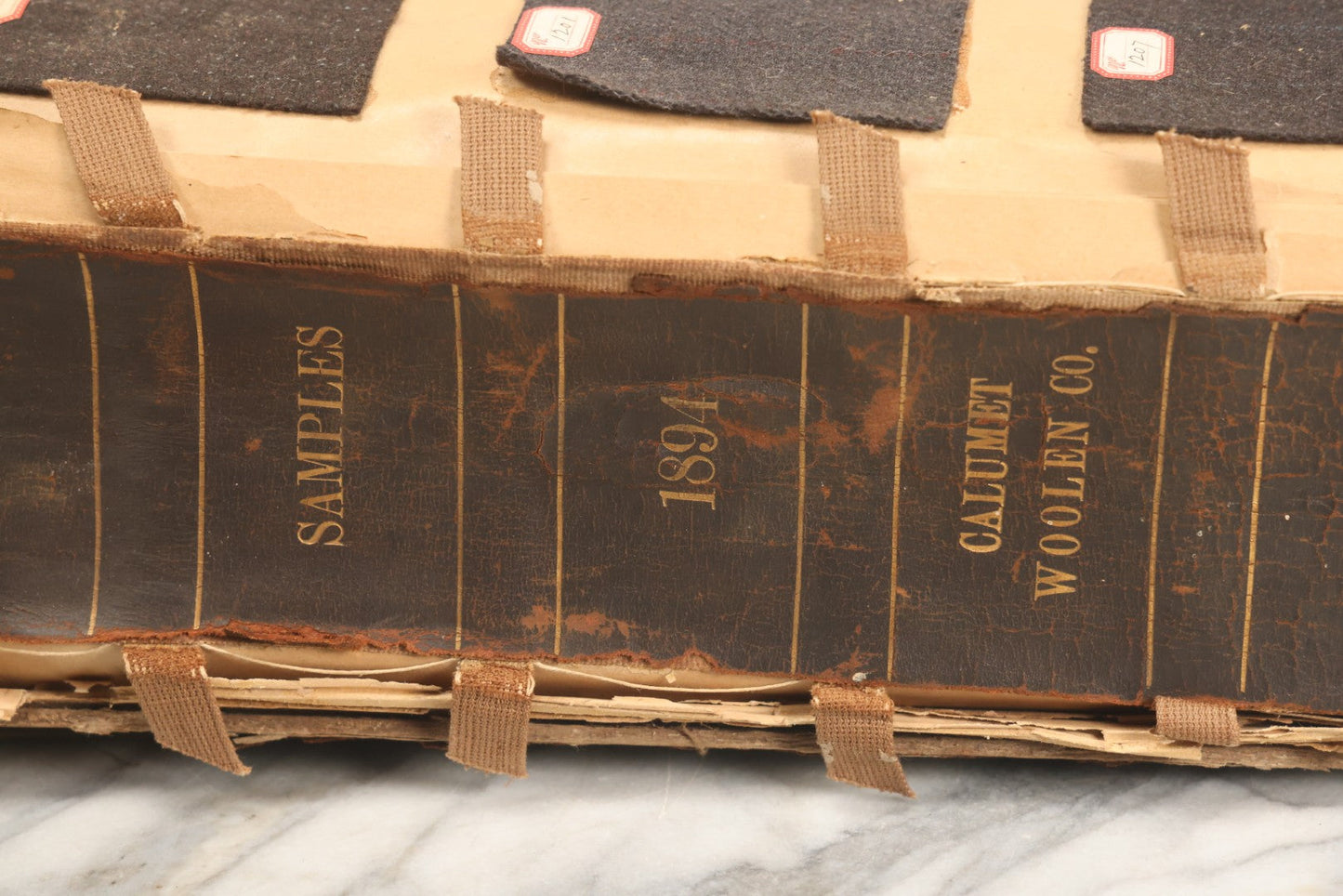 Lot 032 - Antique Sample Fabric Wool Swatch Book From Calumet Woolen Co., Styles No. 1195-1661 & Great River Woolen Co., Styles No. 1-1303, Containing Dozens Of Fabric Samples, Missing Front Cover, Dated 1894 