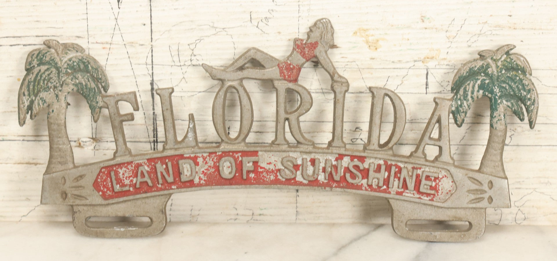 Lot 036 - Vintage Cast Aluminum Florida "Land Of Sunshine" License Plate Topper With Beach Babe In Bikini, Remnants Of Red And Green Paint