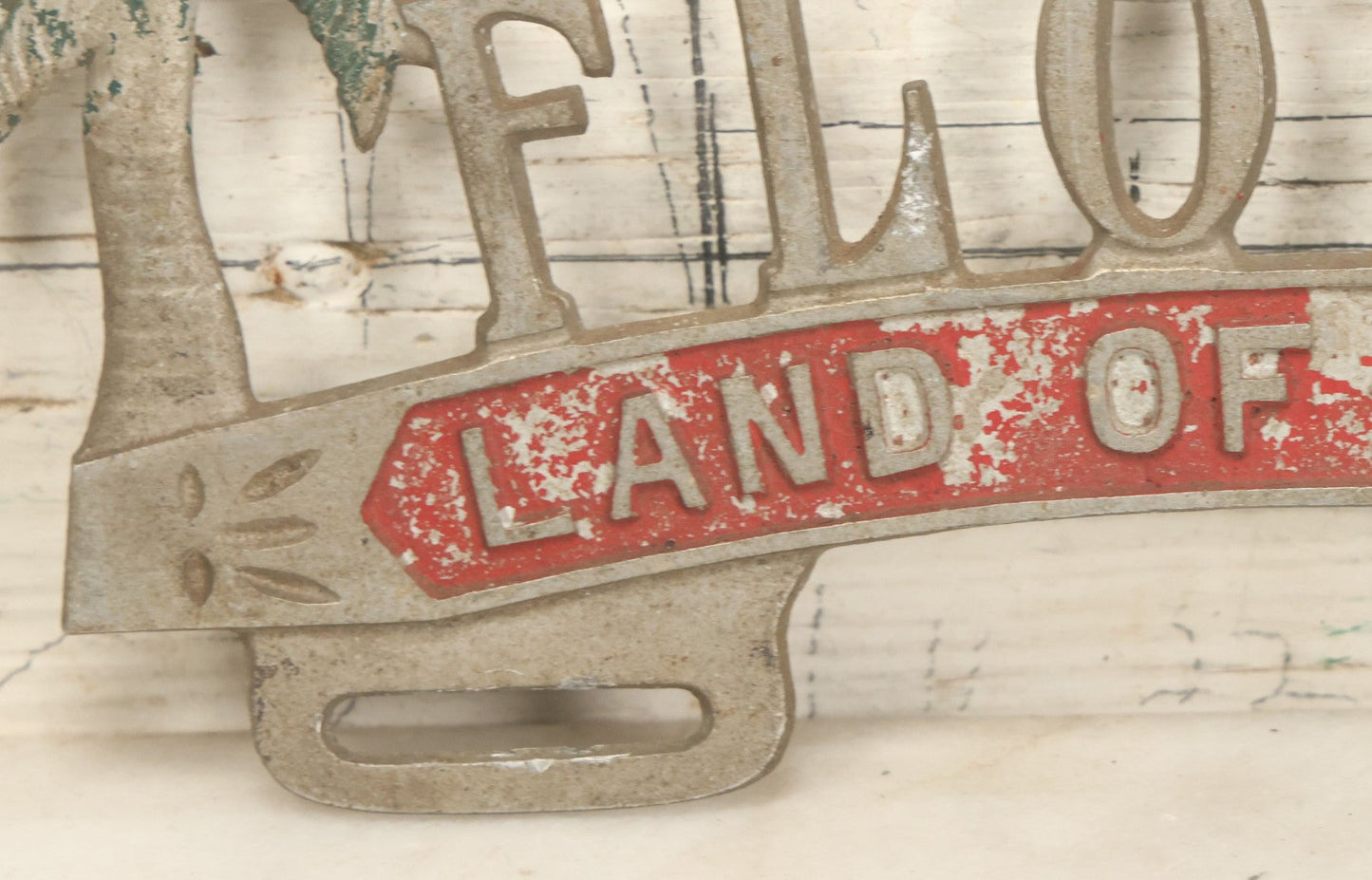 Lot 036 - Vintage Cast Aluminum Florida "Land Of Sunshine" License Plate Topper With Beach Babe In Bikini, Remnants Of Red And Green Paint